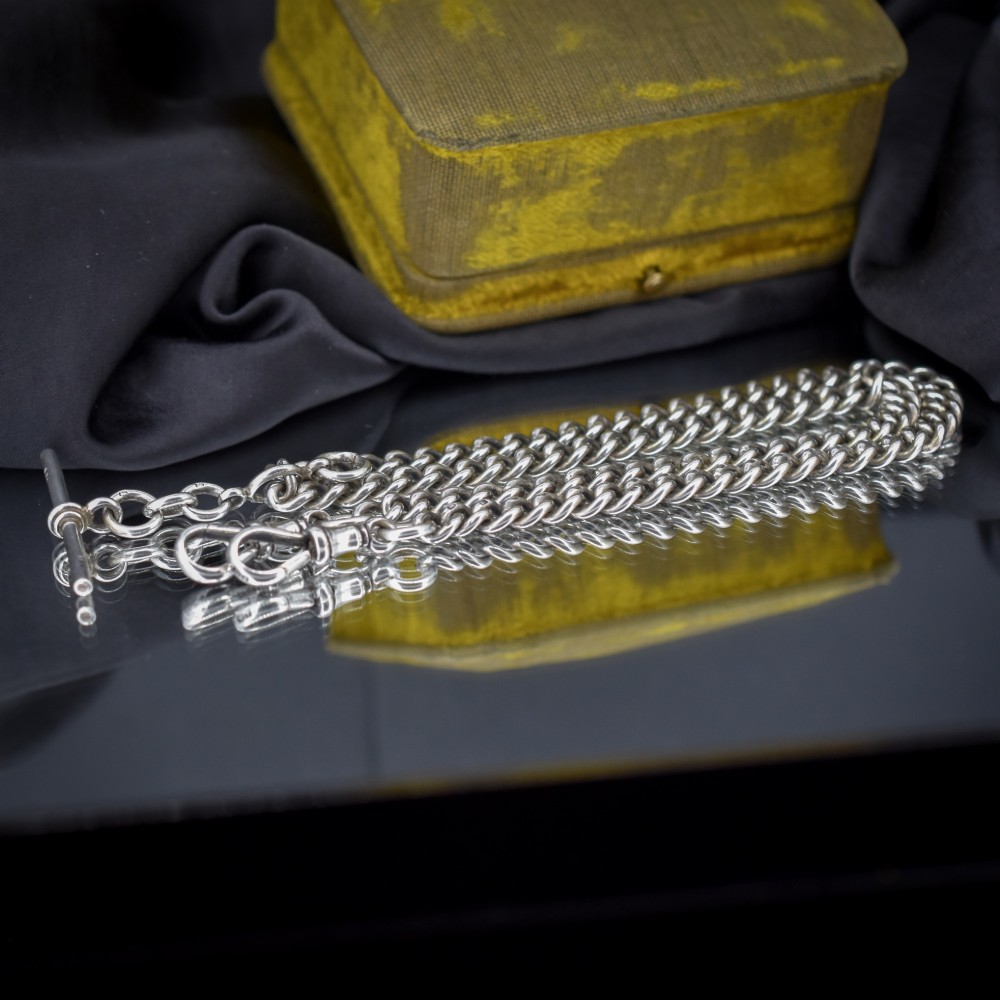An antique sterling silver Albert watch chain featuring heavy curb links, a central T-bar drop, and two swivel dog clip clasps. View VI