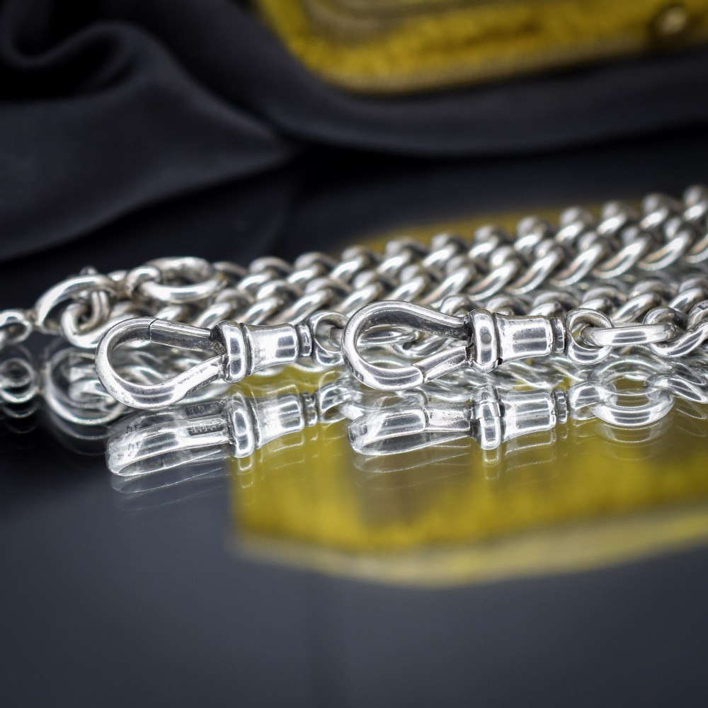 An antique sterling silver Albert watch chain featuring heavy curb links, a central T-bar drop, and two swivel dog clip clasps. View VII