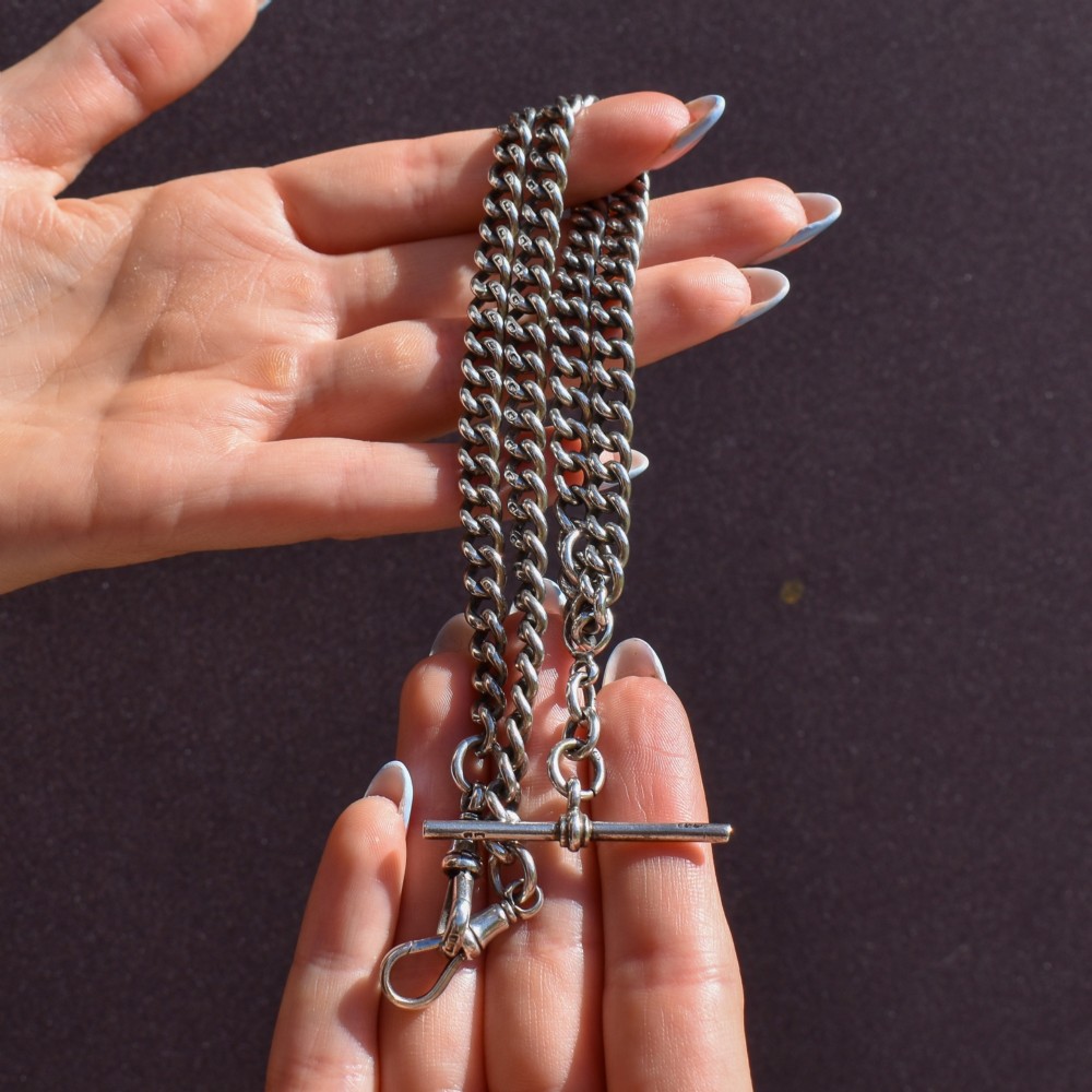 An antique sterling silver Albert watch chain featuring heavy curb links, a central T-bar drop, and two swivel dog clip clasps. View VIII