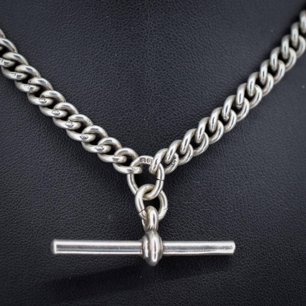 An antique sterling silver uniform curb link Albert watch chain configured as a necklace with a suspended central T-bar. View III