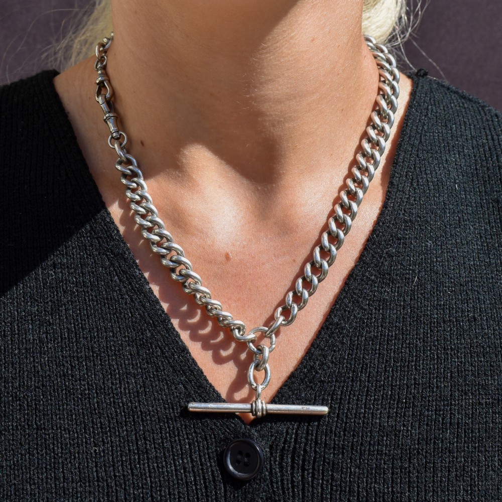An antique sterling silver uniform curb link Albert watch chain configured as a necklace with a suspended central T-bar. View IX