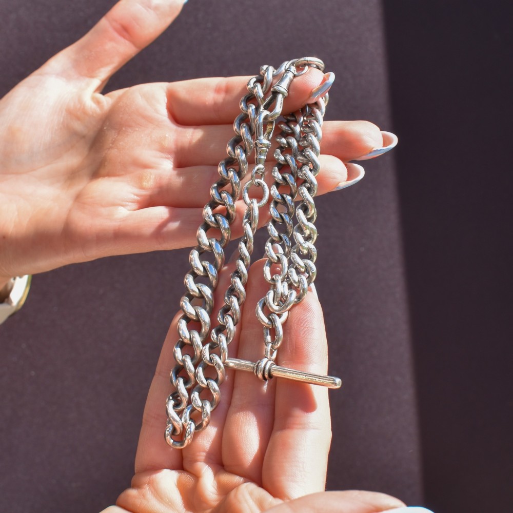 An antique sterling silver uniform curb link Albert watch chain configured as a necklace with a suspended central T-bar. View X