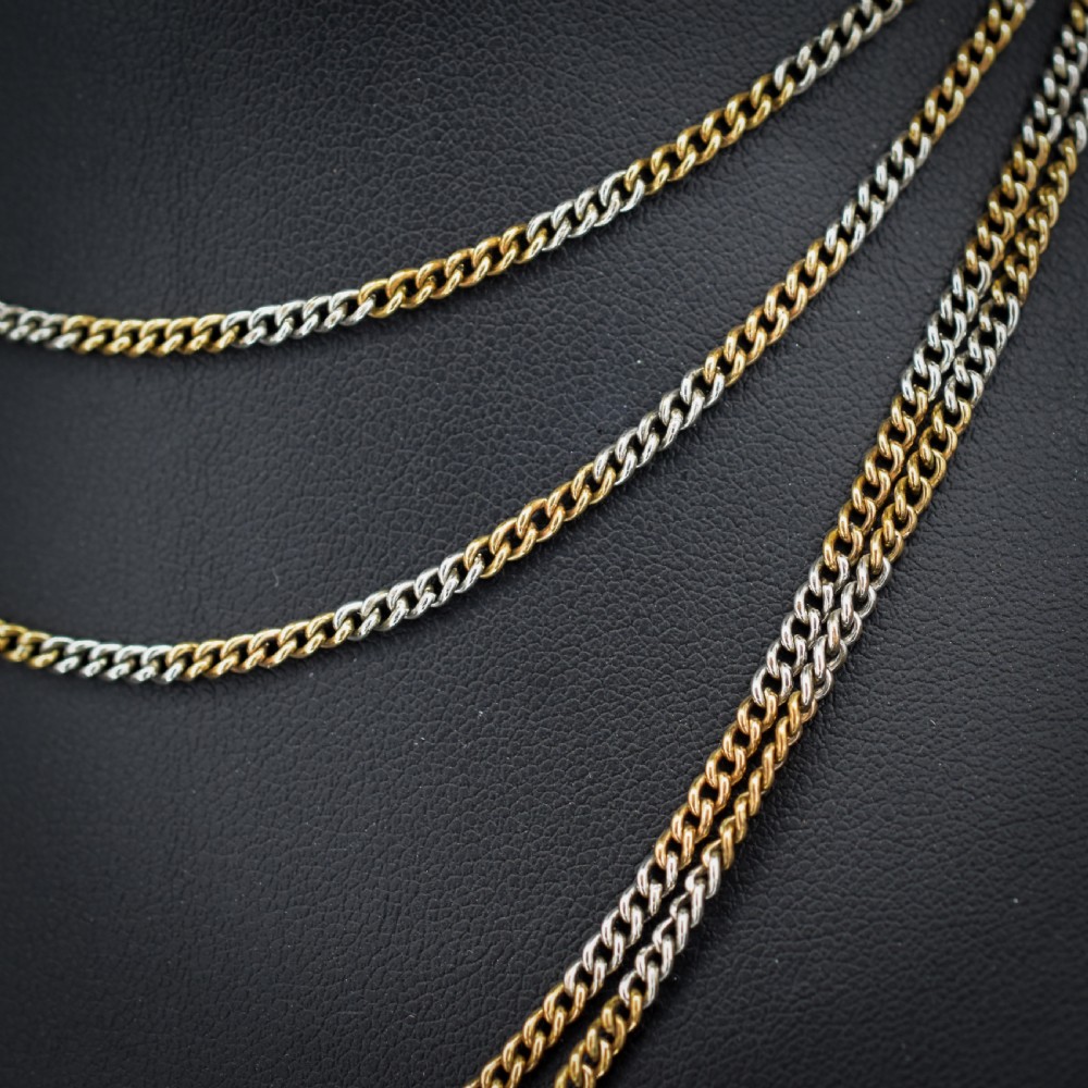 An antique multi-tone metal curb guard chain wrapped in multiple loops with an attached dog clip clasp. View IV