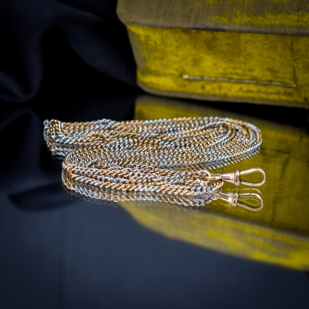 An antique multi-tone metal curb guard chain wrapped in multiple loops with an attached dog clip clasp. View VI