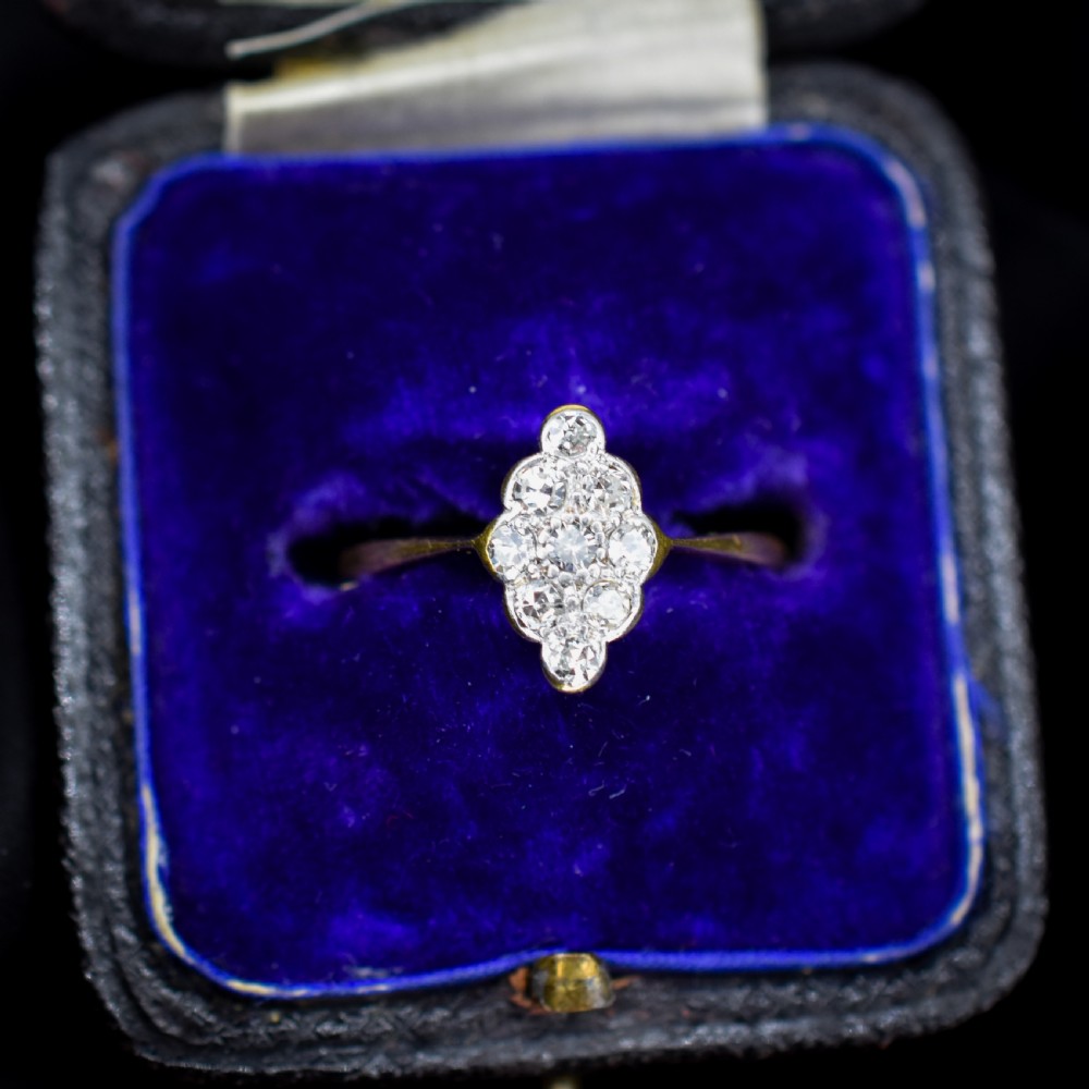 An antique diamond navette cluster ring set in platinum with an 18ct yellow gold band.