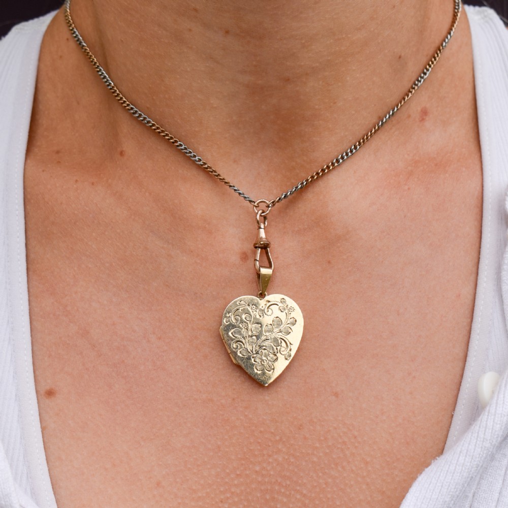 A heart-shaped sterling silver pendant paved with hand-cut clear glass paste stones featuring an ornate bail. View VII