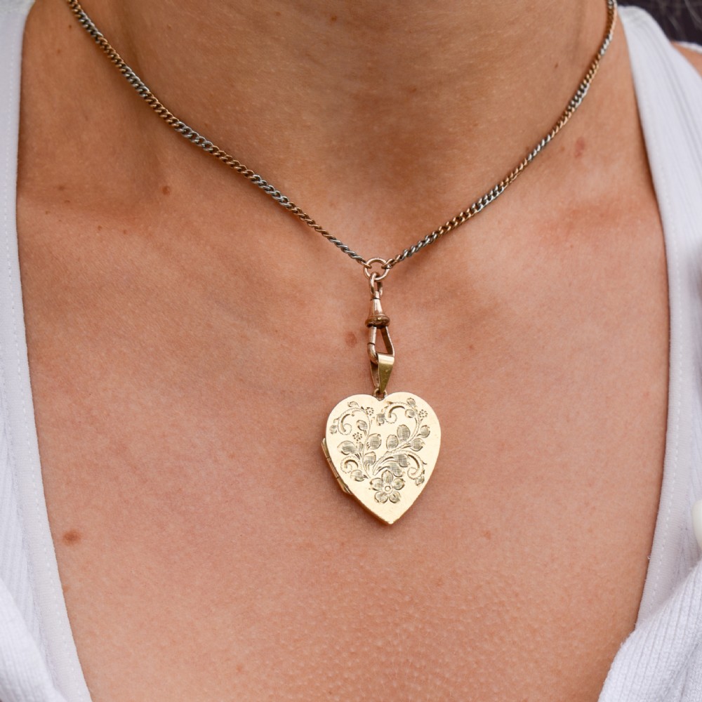 A heart-shaped sterling silver pendant paved with hand-cut clear glass paste stones featuring an ornate bail. View VIII