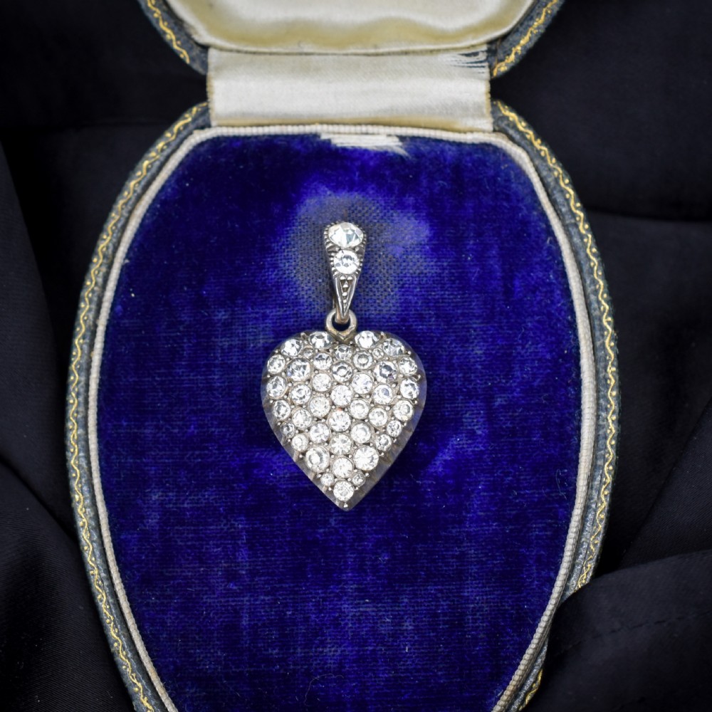 A heart-shaped sterling silver pendant paved with hand-cut clear glass paste stones featuring an ornate bail. View IX
