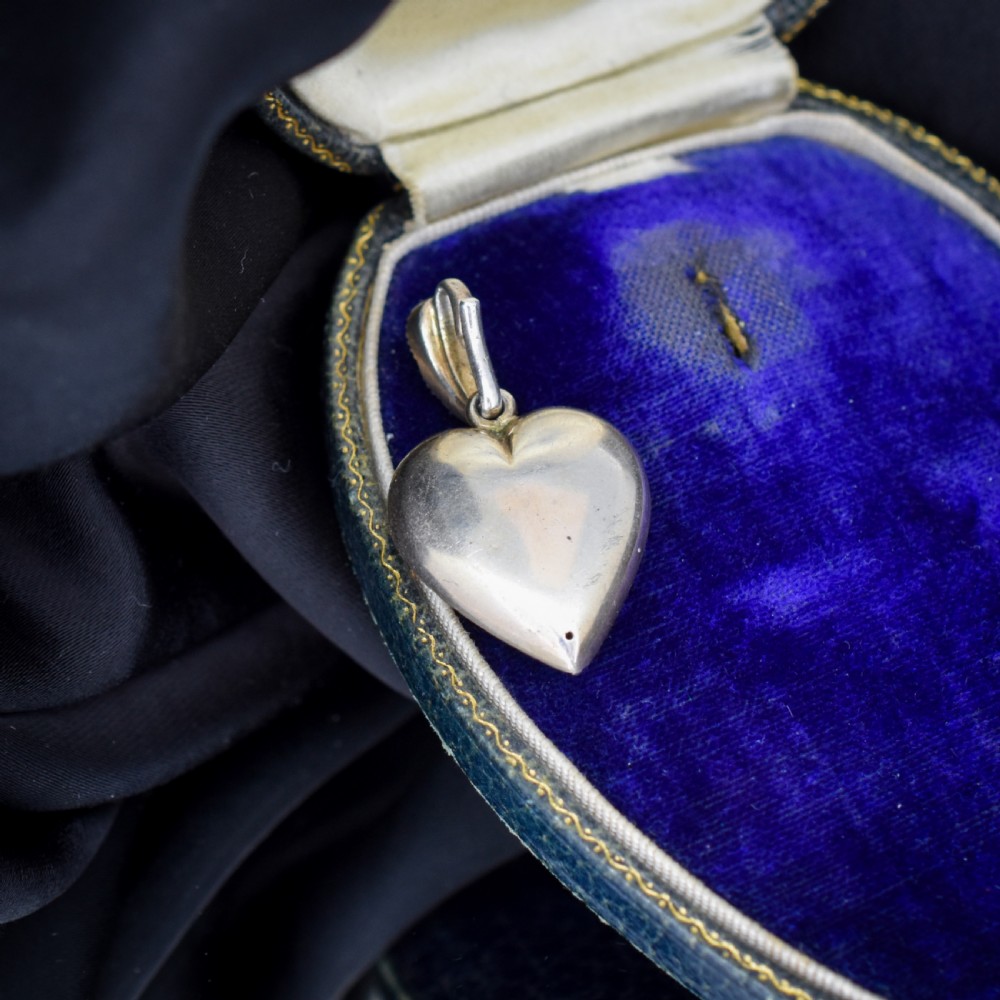 A heart-shaped sterling silver pendant paved with hand-cut clear glass paste stones featuring an ornate bail. View XI