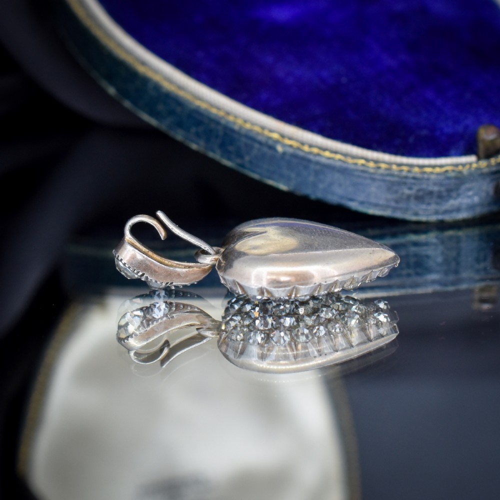A heart-shaped sterling silver pendant paved with hand-cut clear glass paste stones featuring an ornate bail. View XII