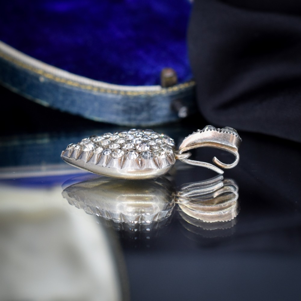 A heart-shaped sterling silver pendant paved with hand-cut clear glass paste stones featuring an ornate bail. View XIII