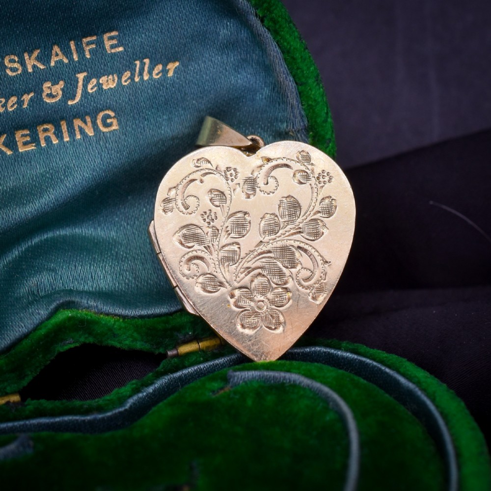 A heart-shaped sterling silver pendant paved with hand-cut clear glass paste stones featuring an ornate bail. View XIV