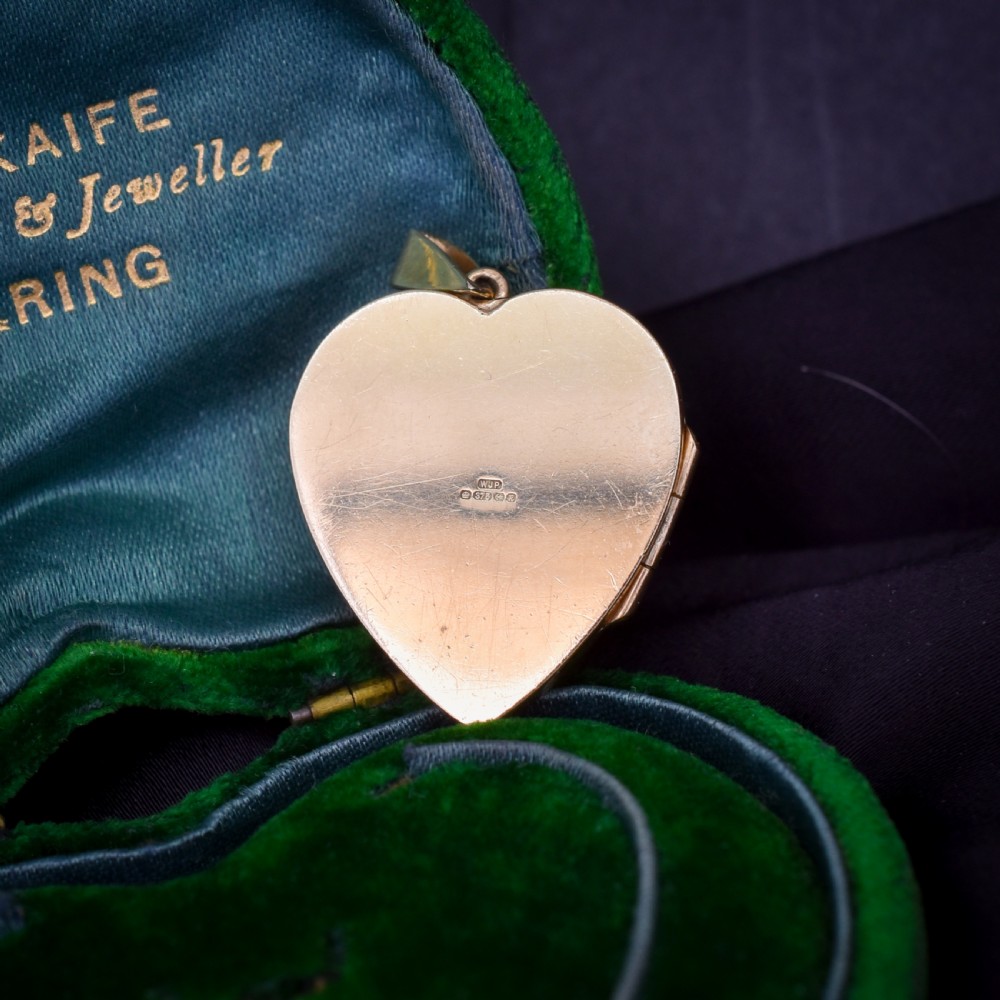 A heart-shaped sterling silver pendant paved with hand-cut clear glass paste stones featuring an ornate bail. View XV