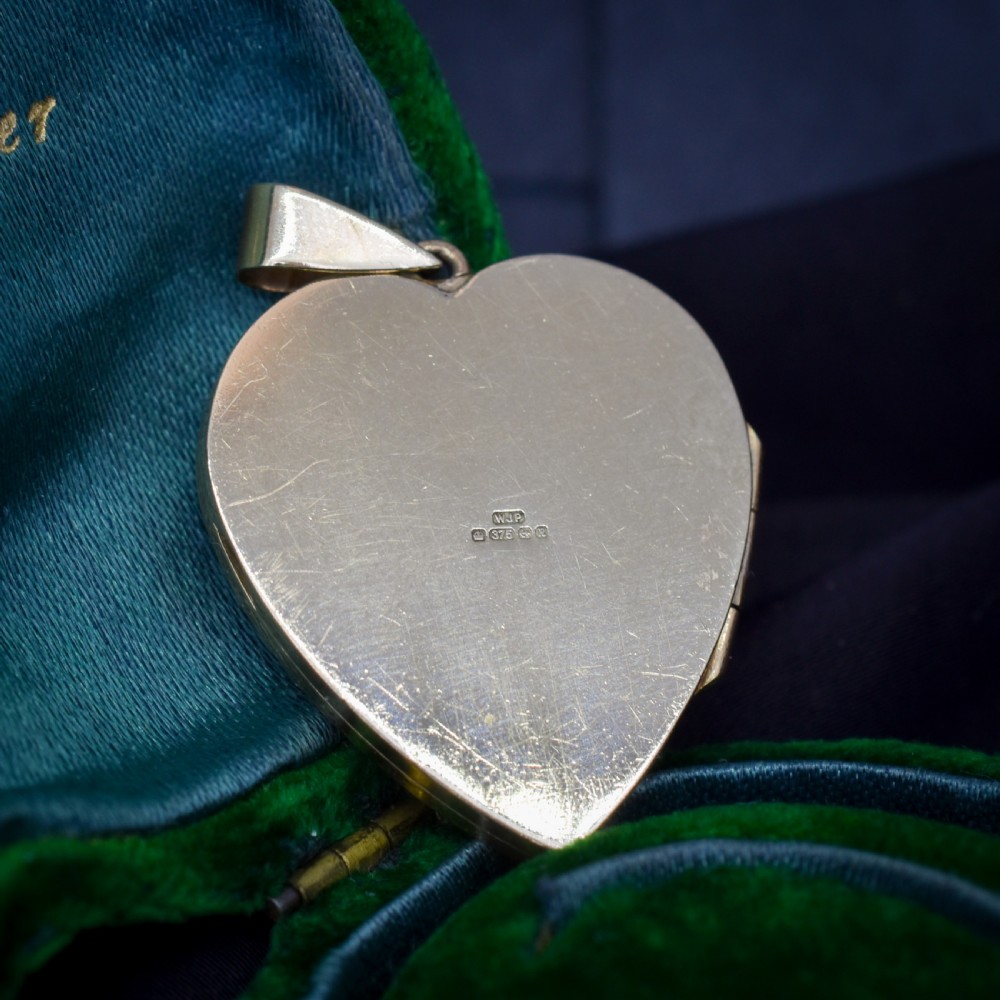A heart-shaped sterling silver pendant paved with hand-cut clear glass paste stones featuring an ornate bail. View XVI