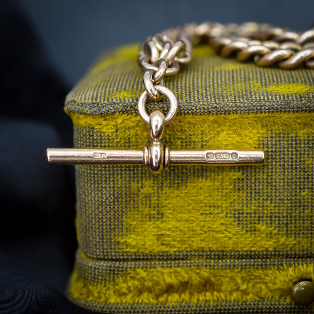 An antique 9ct gold graduated curb link Albert watch chain featuring a central T-bar and twin swivel dog clips. View II
