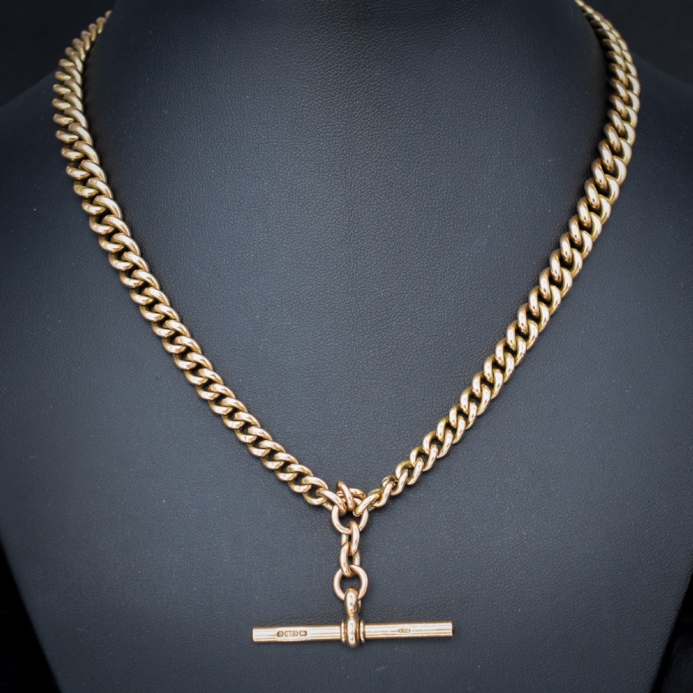 An antique 9ct gold graduated curb link Albert watch chain featuring a central T-bar and twin swivel dog clips. View VI