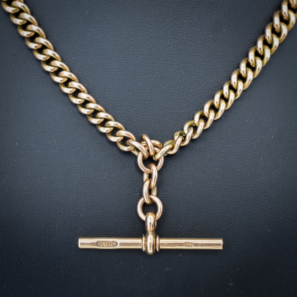 An antique 9ct gold graduated curb link Albert watch chain featuring a central T-bar and twin swivel dog clips. View VII