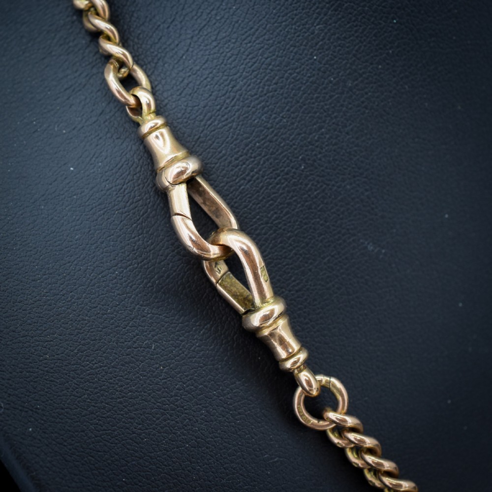 An antique 9ct gold graduated curb link Albert watch chain featuring a central T-bar and twin swivel dog clips. View IX