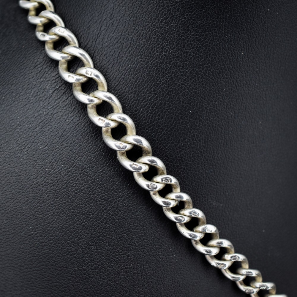An antique sterling silver curb link watch chain featuring a classic T-bar pendant. View II