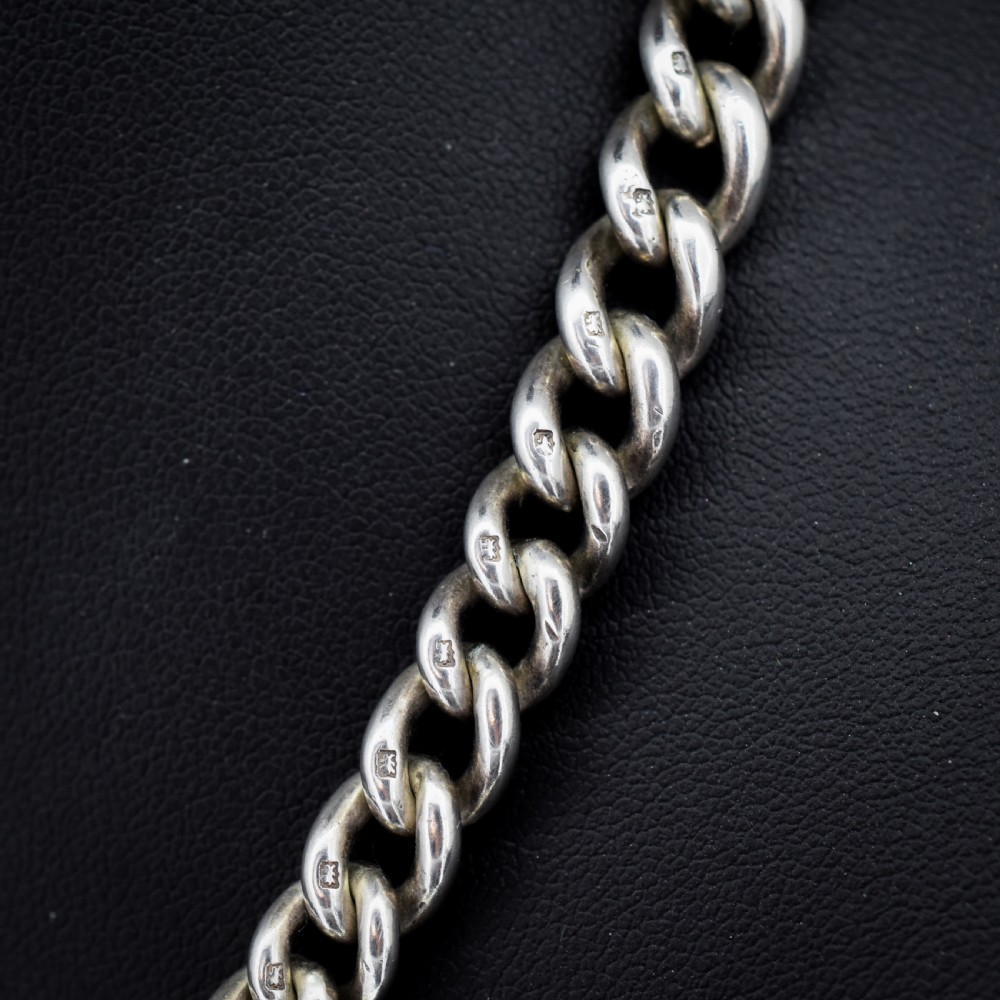 An antique sterling silver curb link watch chain featuring a classic T-bar pendant. View IV