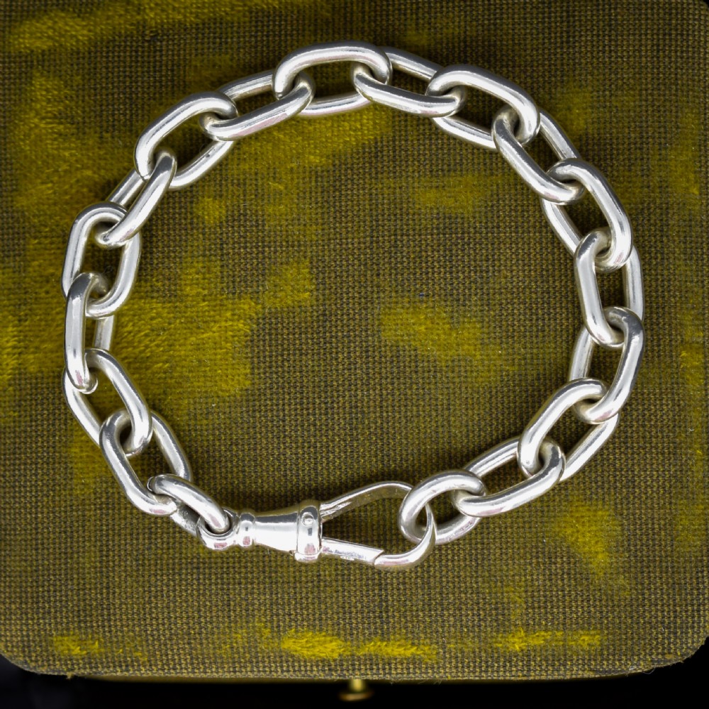 A chunky sterling silver link bracelet with polished oval links secured by a swivel dog clip clasp.