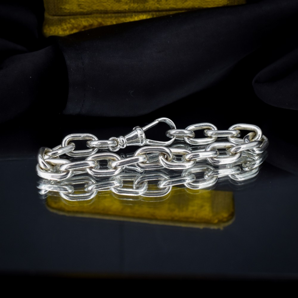 A chunky sterling silver link bracelet with polished oval links secured by a swivel dog clip clasp. View III