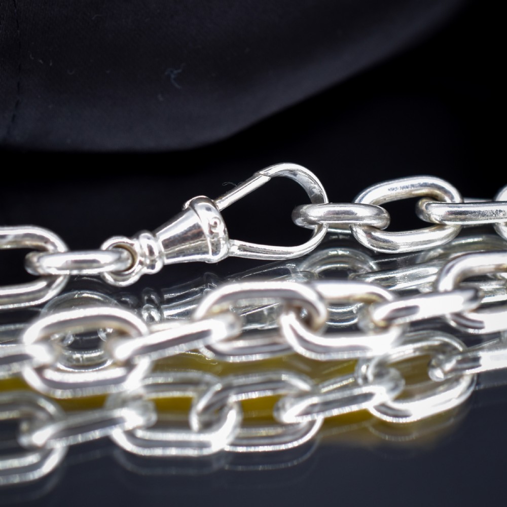 A chunky sterling silver link bracelet with polished oval links secured by a swivel dog clip clasp. View IV