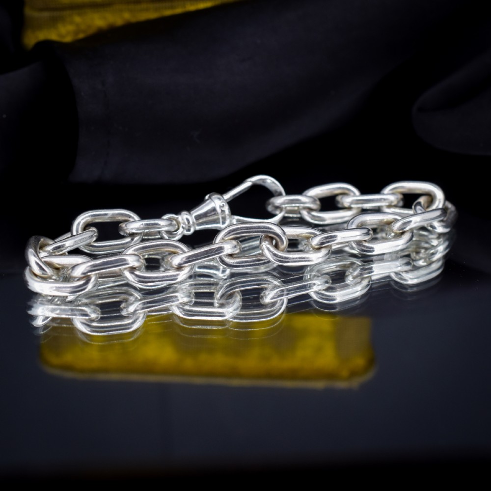 A chunky sterling silver link bracelet with polished oval links secured by a swivel dog clip clasp. View V