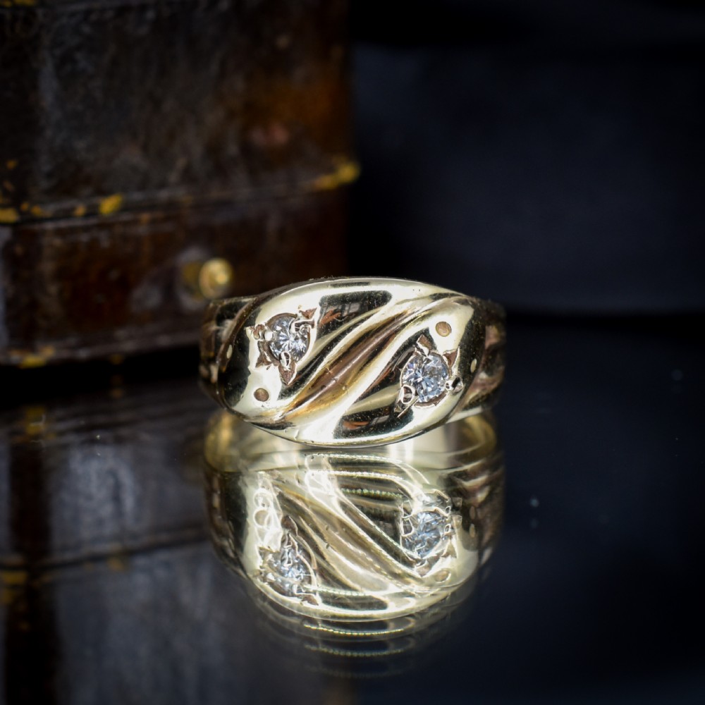 A yellow gold band featuring two entwined snake heads, each set with a star-engraved diamond. View III