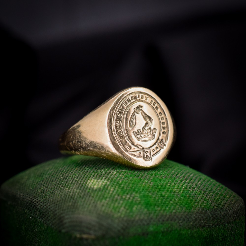 A vintage 9ct yellow gold signet ring featuring an oval bezel hand-engraved with a crest intaglio design. View II