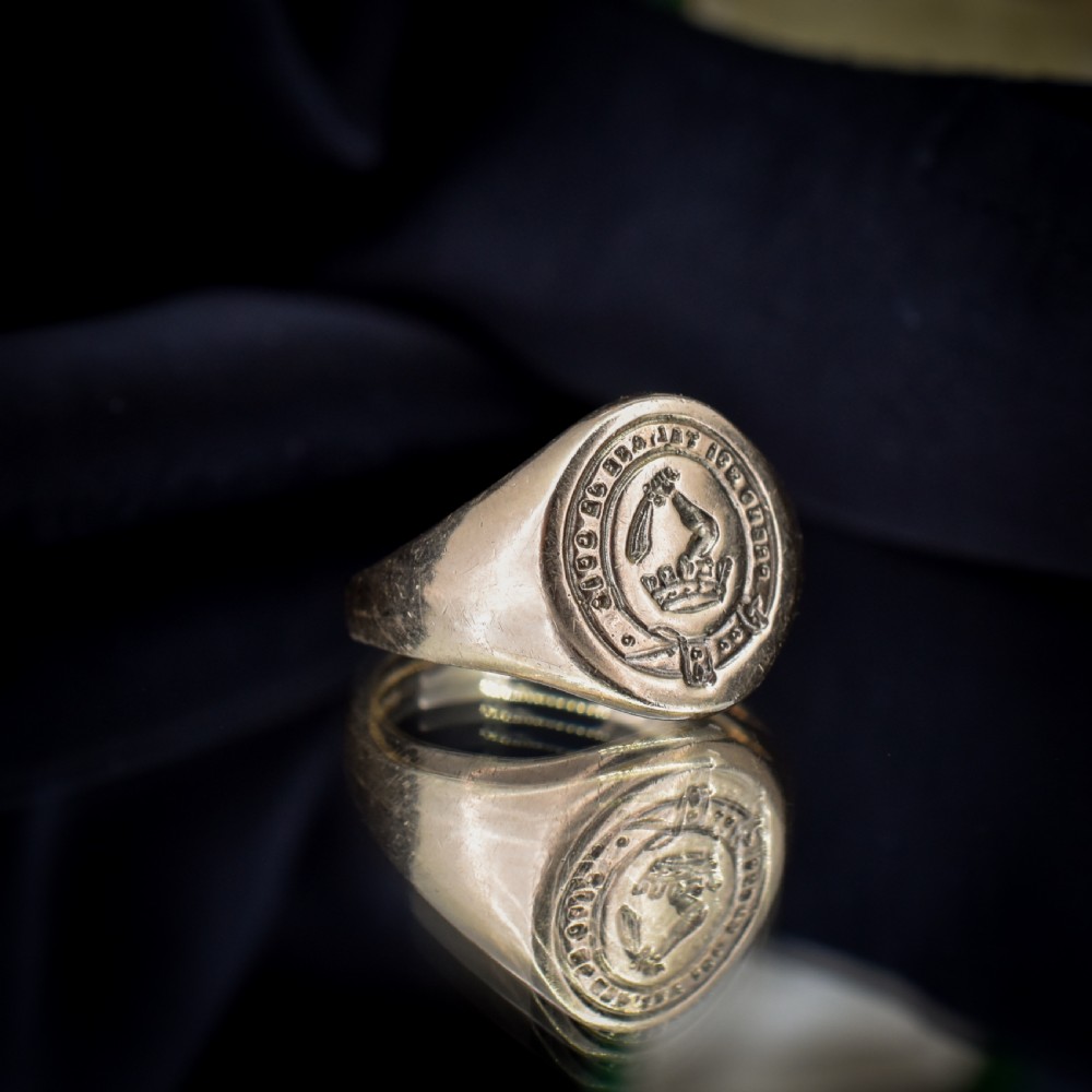 A vintage 9ct yellow gold signet ring featuring an oval bezel hand-engraved with a crest intaglio design. View V