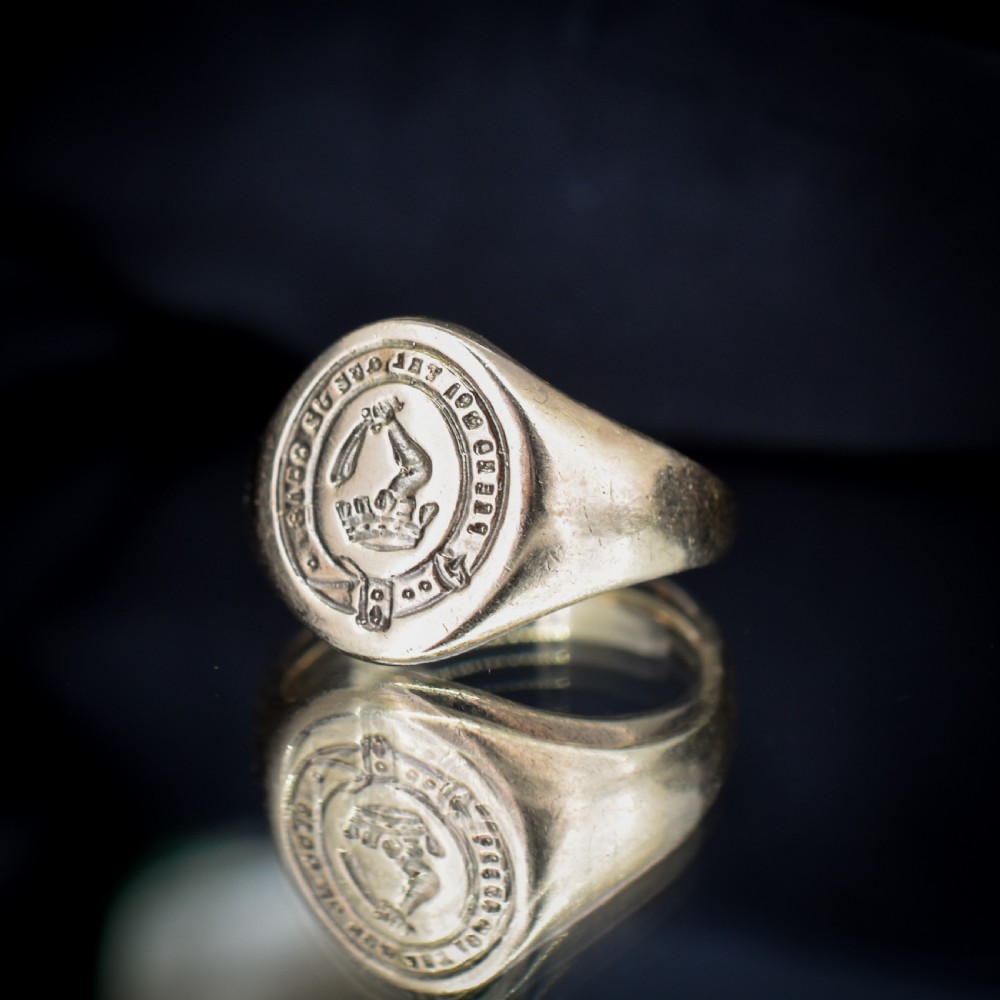 A vintage 9ct yellow gold signet ring featuring an oval bezel hand-engraved with a crest intaglio design. View VII