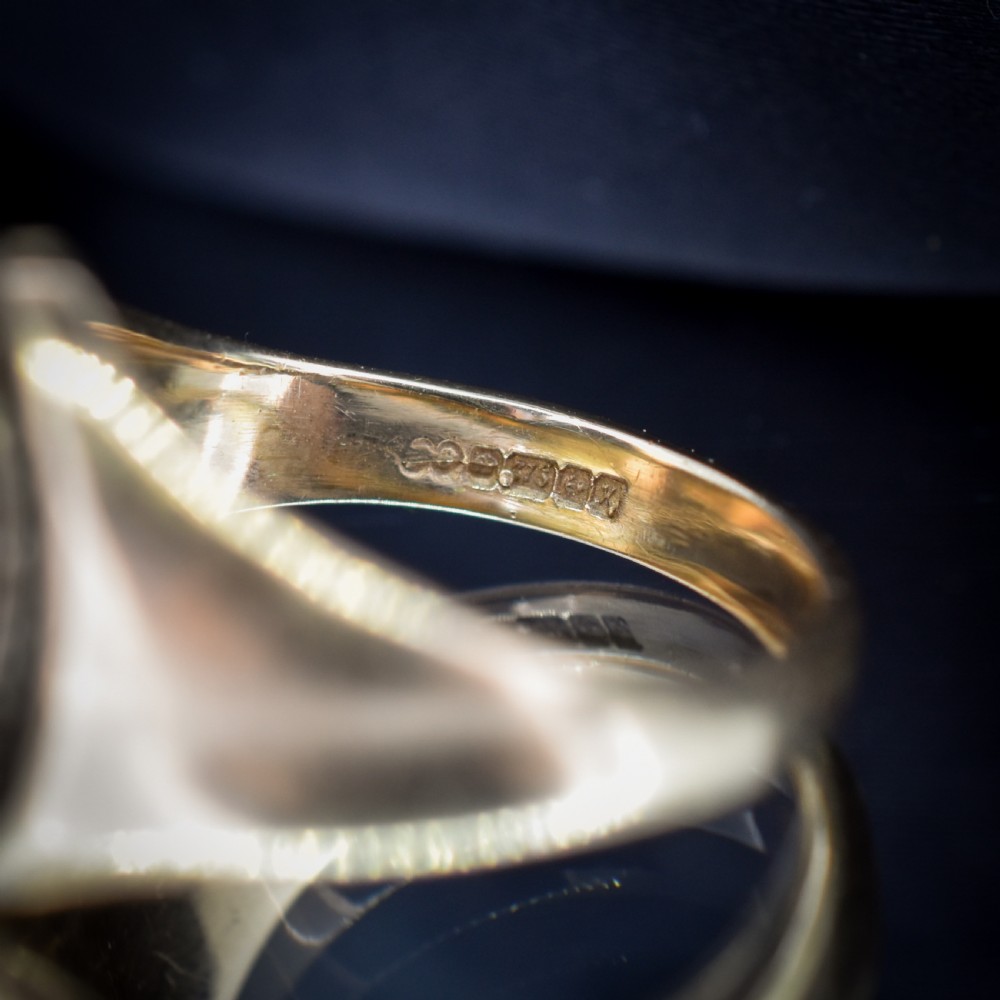 A vintage 9ct yellow gold signet ring featuring an oval bezel hand-engraved with a crest intaglio design. View VIII