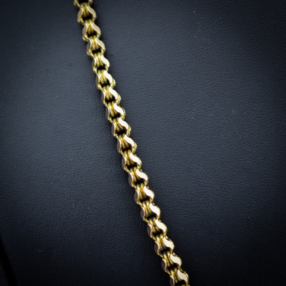 A Victorian 15ct yellow gold fancy link chain necklace fitted with a dog clip fastener. View II