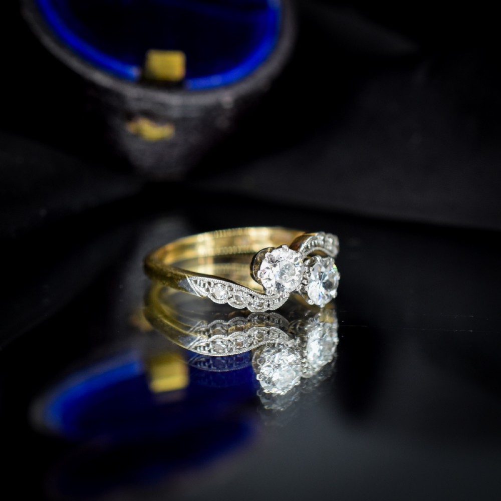 An antique diamond Toi et Moi ring featuring two diamonds set in a platinum crossover mount on an eighteen carat gold band. View V