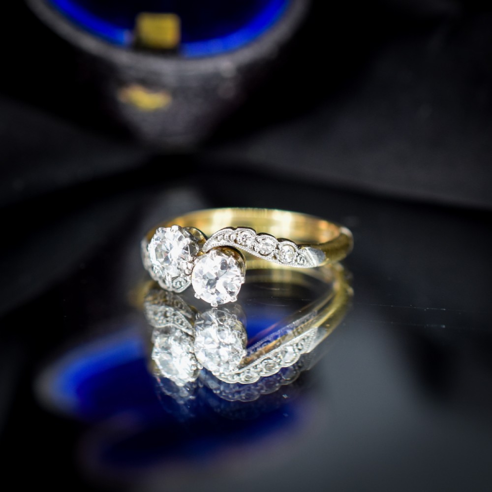 An antique diamond Toi et Moi ring featuring two diamonds set in a platinum crossover mount on an eighteen carat gold band. View VII