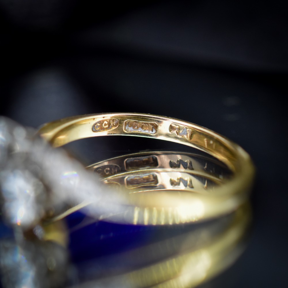 An antique diamond Toi et Moi ring featuring two diamonds set in a platinum crossover mount on an eighteen carat gold band. View VIII