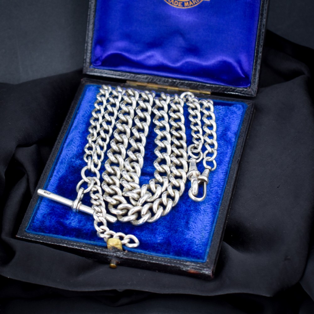 A sterling silver curb link Albert watch chain necklace featuring a central T-bar attachment and swivel clasp on a black bust. View III