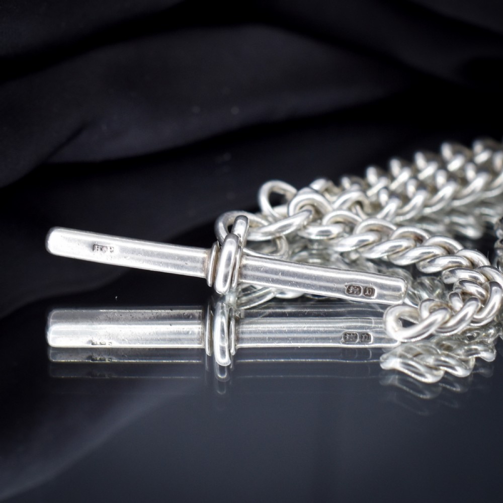 A sterling silver curb link Albert watch chain necklace featuring a central T-bar attachment and swivel clasp on a black bust. View IV
