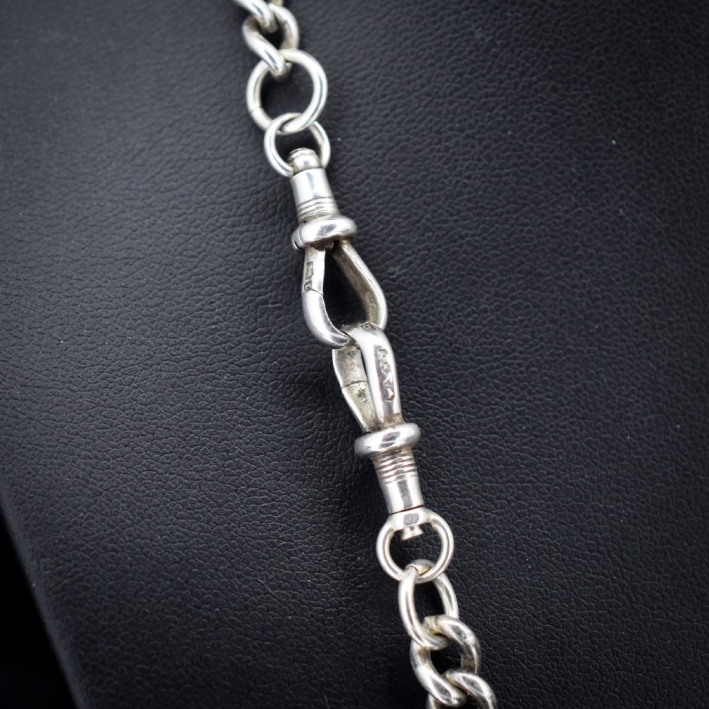 A sterling silver uniform curb link necklace with a T-bar pendant and dog clip clasp displayed on a black neck bust. View III