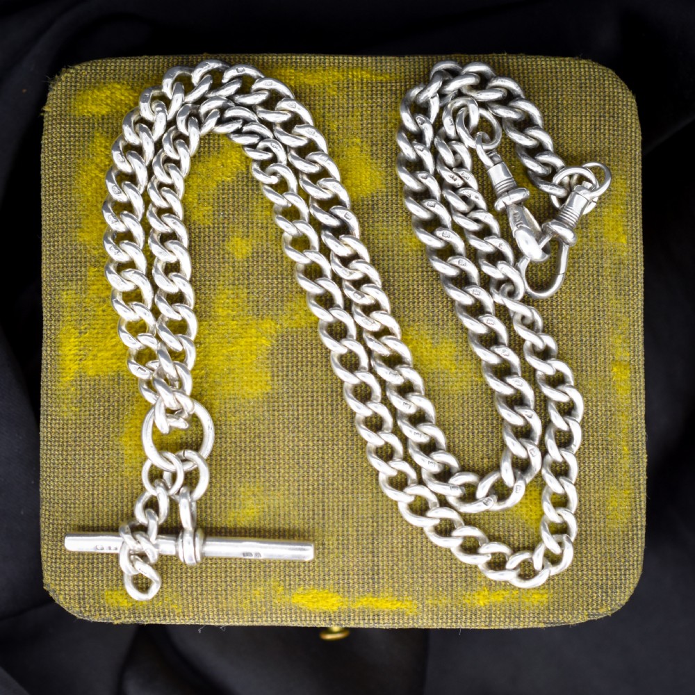 A sterling silver uniform curb link necklace with a T-bar pendant and dog clip clasp displayed on a black neck bust. View IV