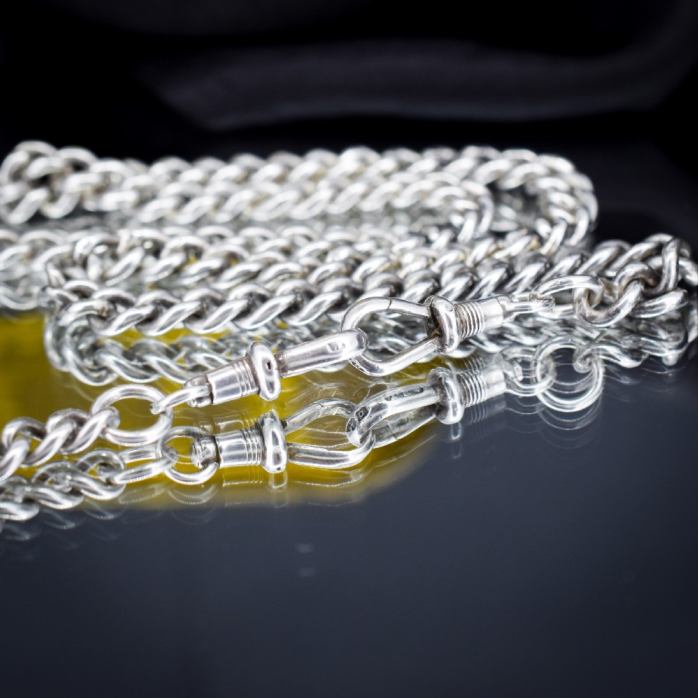 A sterling silver uniform curb link necklace with a T-bar pendant and dog clip clasp displayed on a black neck bust. View V