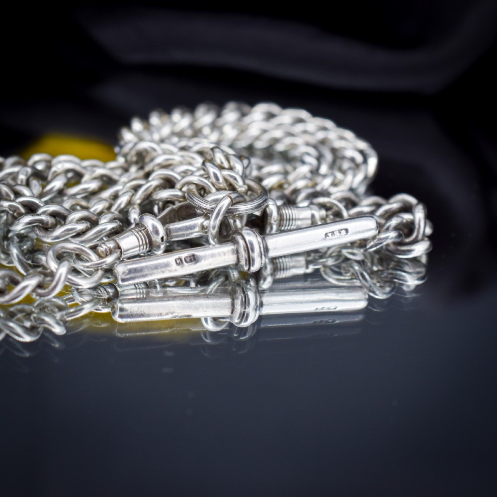 A sterling silver uniform curb link necklace with a T-bar pendant and dog clip clasp displayed on a black neck bust. View VI