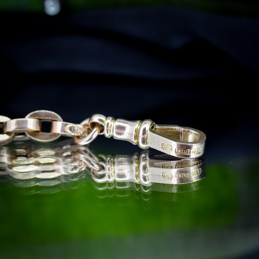 An antique 9ct yellow gold bracelet featuring uniform oval cable links secured with a swivel dog clip fastener. View III