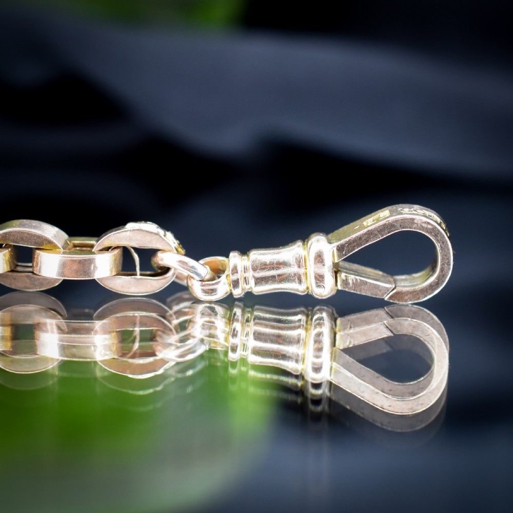An antique 9ct yellow gold bracelet featuring uniform oval cable links secured with a swivel dog clip fastener. View IV