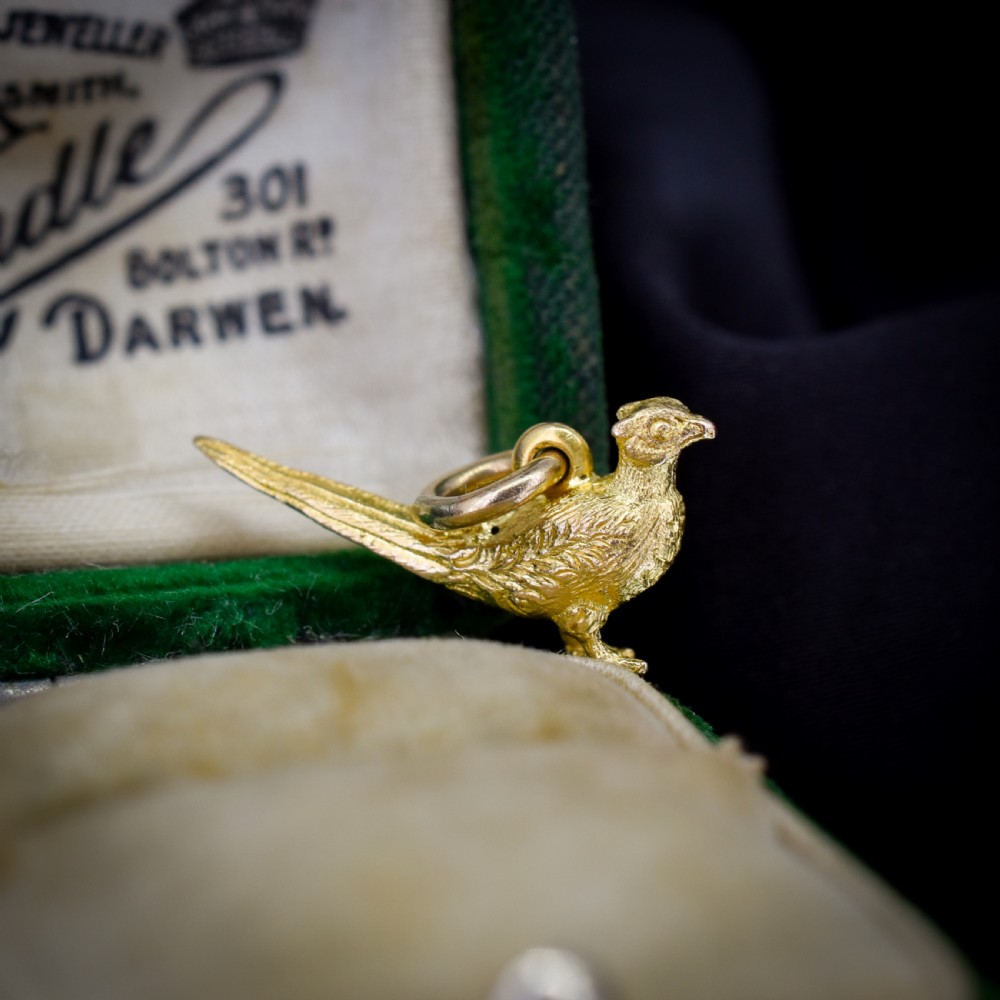 A detailed three-dimensional 9ct yellow gold pheasant bird charm with textured feathers and an attached jump ring.