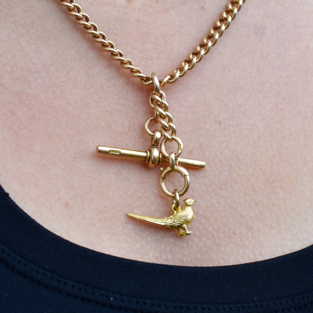 A detailed three-dimensional 9ct yellow gold pheasant bird charm with textured feathers and an attached jump ring. View VI