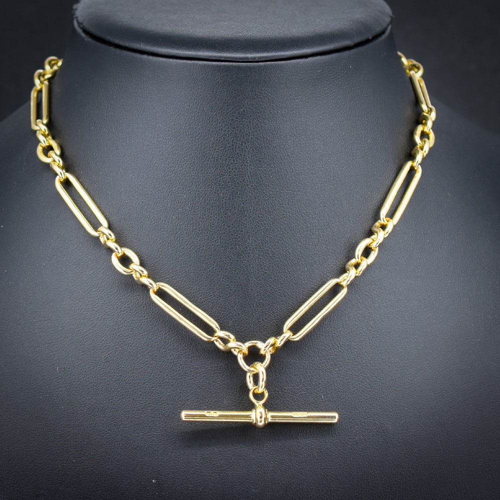 An antique 18ct yellow gold trombone link watch chain featuring an integrated T-bar and swivel clasp fastener. View II