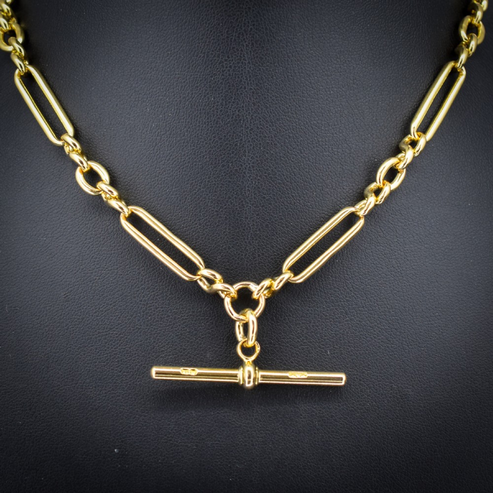 An antique 18ct yellow gold trombone link watch chain featuring an integrated T-bar and swivel clasp fastener. View III