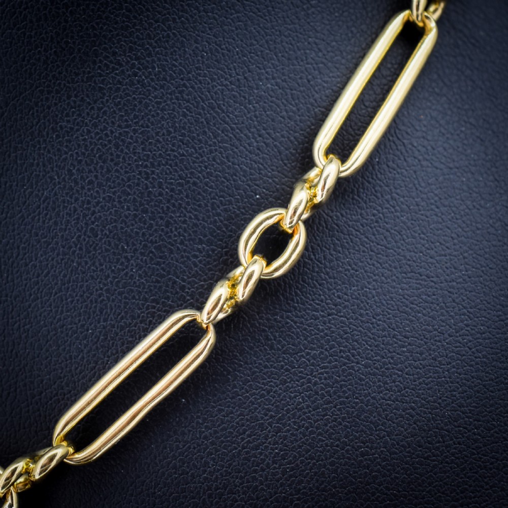 An antique 18ct yellow gold trombone link watch chain featuring an integrated T-bar and swivel clasp fastener. View IV